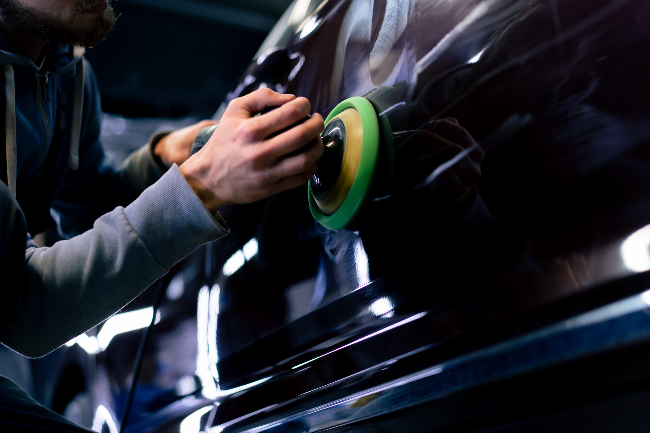 Machine polishing car paint during a paint correction